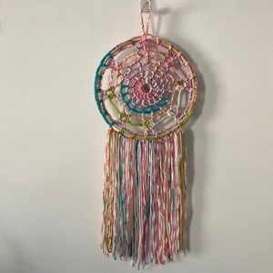 Boho dream catcher with multicolored, variegated yarn and center decor piece